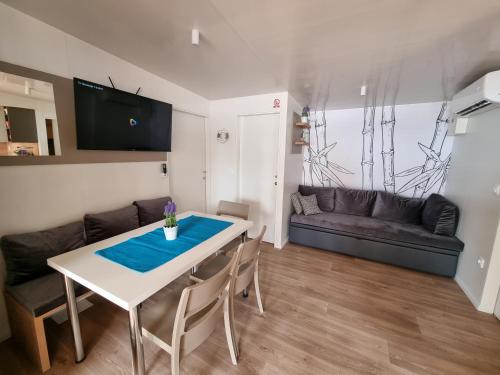 a living room with a white table and a couch at Memita Mobile homes, Selce in Selce