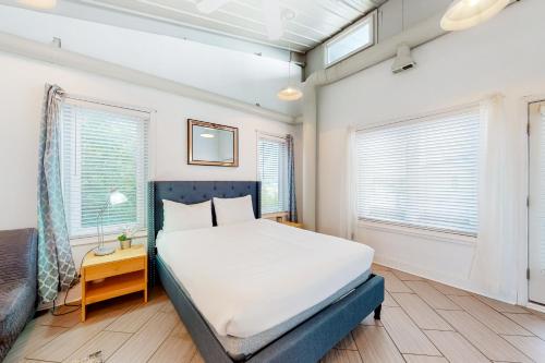 a bedroom with a bed and two windows at Rehoboth Beach -- Forj Lofts #8 in Rehoboth Beach
