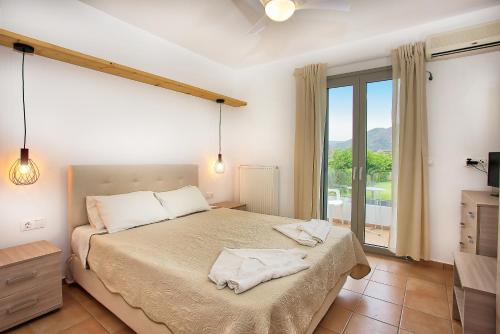 Posteľ alebo postele v izbe v ubytovaní Achilli Apartments