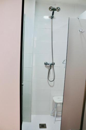 a bathroom with a shower and a sink at Albergue Puente para peregrinos in Puente la Reina