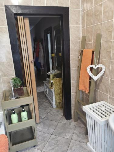 a bathroom with a mirror and a room with a sink at VESA Guesthouse in Meyerton