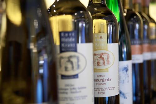 un gruppo di bottiglie di vino sedute l'una accanto all'altra di Gasthaus Huwer a Bernkastel-Kues