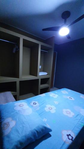 a bedroom with a bed with a blue blanket with dolls on it at Bedroom Airport in Maceió