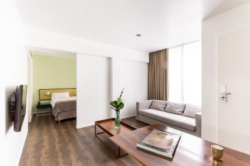 a living room with a couch and a table at Hotel BA Jardines Palermo in Buenos Aires