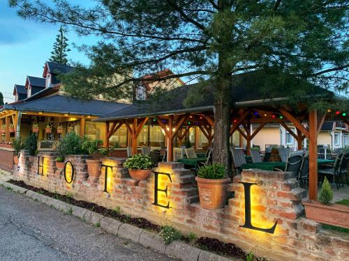 a restaurant with a brick wall with the word eat in front of it at Hotel Zéta in Lenti
