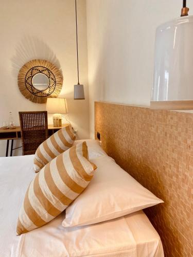 a bedroom with a bed with pillows on it at VICTORIA - by Ático73 in Medina Sidonia