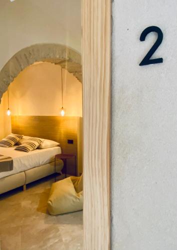 a room with two beds and a number on the wall at VICTORIA - by Ático73 in Medina Sidonia