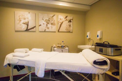 a hospital room with a bed and flowers on the wall at Bed & Breakfast Van Marion in Oostvoorne