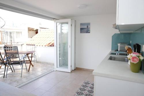 a kitchen with a sink and a table at Holiday Home Yan with bay view in Vodice