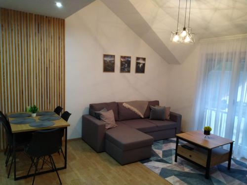 a living room with a couch and a table at King's Cave deluxe in Jajce