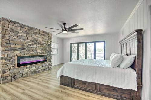 a bedroom with a stone wall and a ceiling fan at Waterfront Gravois Mills Home Deck and Grill! in Gravois Mills