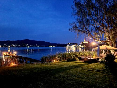 a view of a lake at night at Haus am See in Maria Wörth