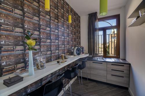 a bathroom with a counter with a sink and a window at Blue Inn Luxury Suites in Rome