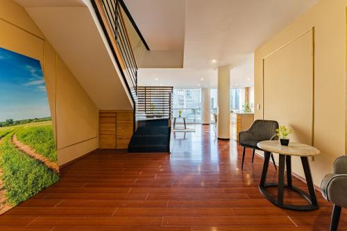 a room with a staircase with a view of a green field at Antara apartments by VH in Mexico City