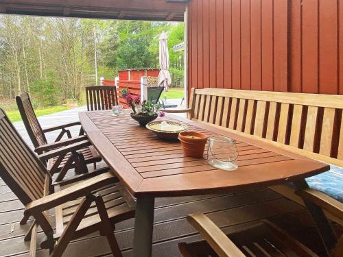 a wooden table on a deck with bowls of food on it at 6 person holiday home in Hemmet in Hemmet