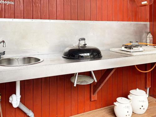 a kitchen with a counter with a sink and a stove at 6 person holiday home in Hemmet in Hemmet