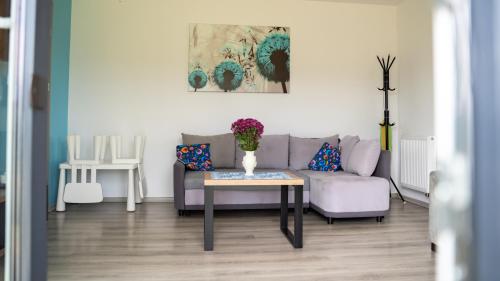 a living room with a couch and a table at Domek POD GOLCOWEM in Limanowa