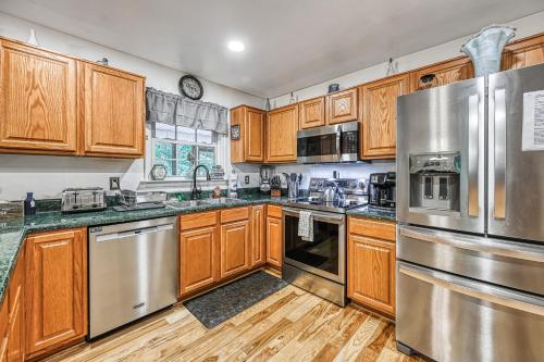 a kitchen with wooden cabinets and stainless steel appliances at Total Escape in Mineral