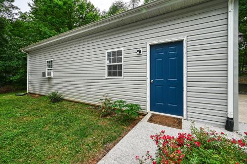 a garage with a blue door in a yard at Total Escape in Mineral
