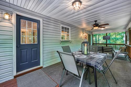 a porch with a table and chairs and a blue door at Total Escape in Mineral