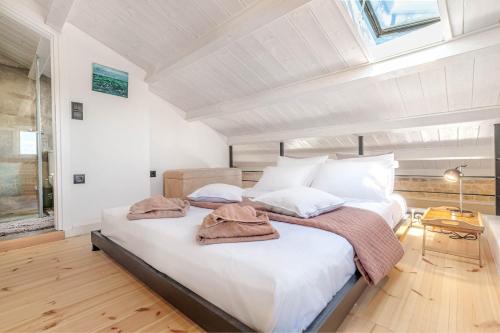 a bedroom with a large bed in a attic at Art Loft Venetian Well in Corfu Town