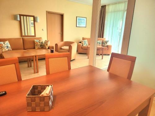 a living room with a table and chairs and a living room at "Красавиците тъмнокоси" Sunset Resort Pomorie in Pomorie