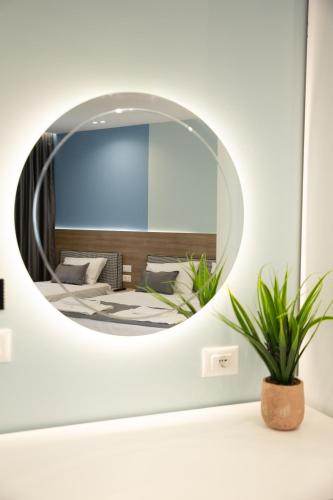 a mirror in a room with a bed at Veranda Boutique Hotel in Vlorë