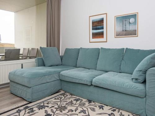 a blue couch sitting in a living room at 4 person holiday home in Fan in Fanø