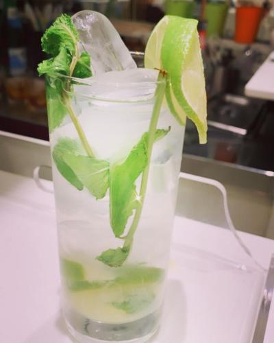 a glass of water with a lime and mint at Hotel Ardea in Riccione