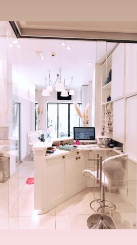 a white kitchen with a desk with a computer on it at Hotel Ardea in Riccione