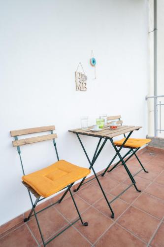a table and two chairs next to a white wall at Dream House Ioannina in Ioannina
