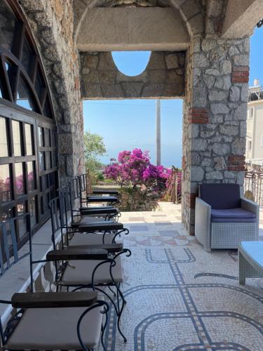 a row of chairs lined up on a patio at Solomon&Sons in Dhërmi