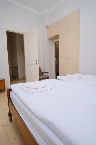 a bedroom with a white bed and a chair at Toon 55 Boutique Hotel in Gyumri