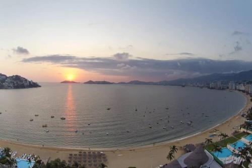 a view of a beach with people in the water at Luxury apartment in front of Acapulco Beach in Acapulco