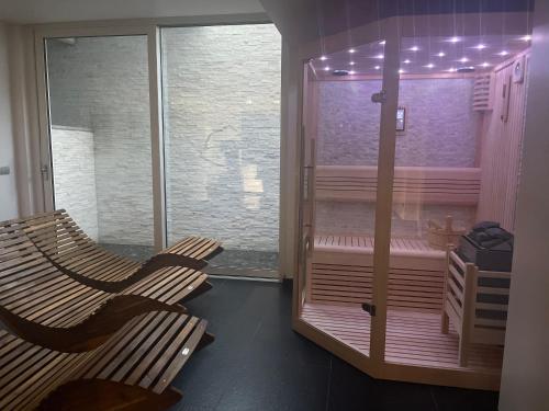 a room with two benches and a window with lights at ROSENSUITE La Residenza del rosengarten in Pinzolo