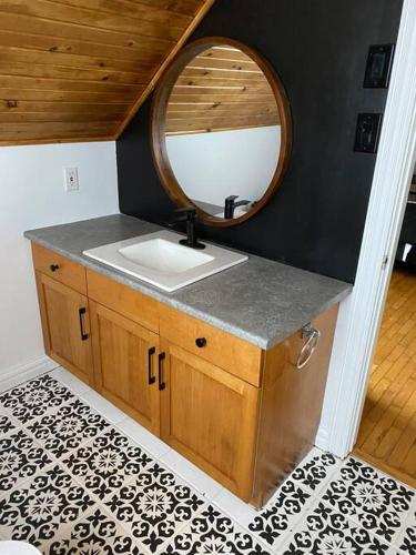a bathroom with a sink and a mirror at Loft apartment in Kensington in Kensington