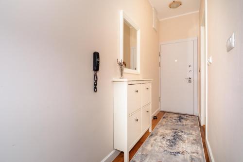 a hallway with a phone hanging on a wall at Soho city apartment in Bar
