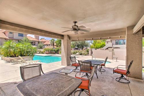 a patio with a table and chairs and a pool at Walk to Park Scottsdale Condo with Community Pool! in Scottsdale
