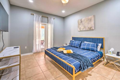 a bedroom with a blue bed and a window at Sunny Clermont Retreat with Lanai 12 Mi to Disney! in Orlando