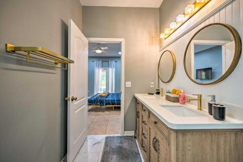 a bathroom with a sink and a mirror at Sunny Clermont Retreat with Lanai 12 Mi to Disney! in Orlando