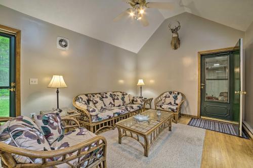 a living room with two couches and a table at Higgins Lake Getaway - Boating, Fish, Golf, ATV! in Roscommon
