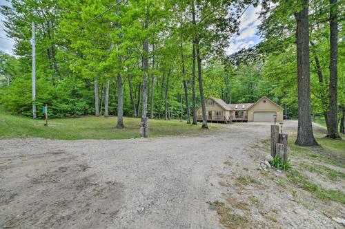 an empty road in front of a house at Higgins Lake Getaway - Boating, Fish, Golf, ATV! in Roscommon