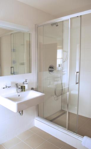 a bathroom with a sink and a shower at Hotel 99 in Chomutov