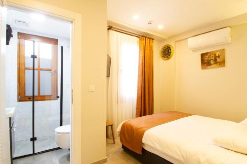 a hotel room with a bed and a toilet at Turna HOTEL in Istanbul