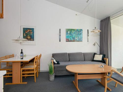 a living room with a couch and a table at Apartment in holiday park with loft, Ringkøbing in Ringkøbing