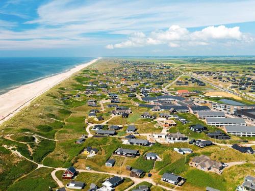 an aerial view of a beach with houses and condos at 6 person holiday home on a holiday park in Ringk bing in Ringkøbing
