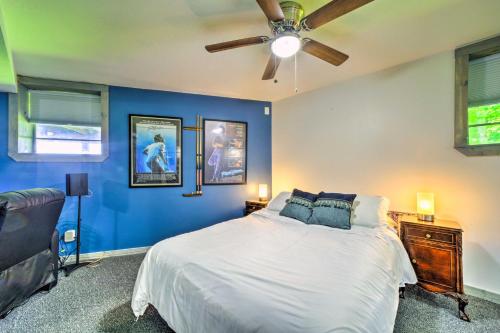 a blue bedroom with a bed and a ceiling fan at Mtn Treehouse with Fire Pit, Breathtaking Views in Waynesville