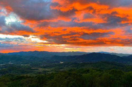 a sunset over the mountains in the hills at Mtn Treehouse with Fire Pit, Breathtaking Views in Waynesville