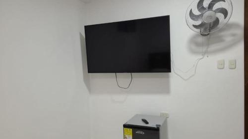 a flat screen tv hanging on a wall at Edificio Tony - Alojamiento Aparta-Hotel in Barrancabermeja