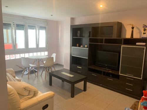 a living room with a large entertainment center with a television at Apartamento con garaje en Paseo Marítimo de Barbate in Barbate